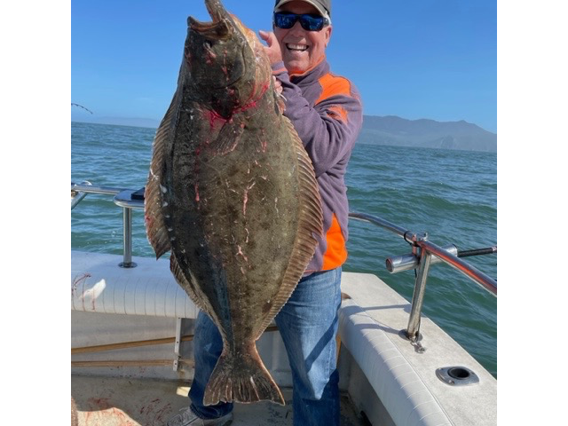 Man Holding A Long Fish